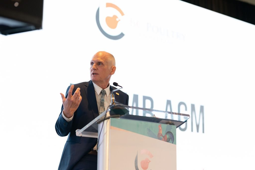 Keynote speaker at a podium during a corporate conference in Vancouver